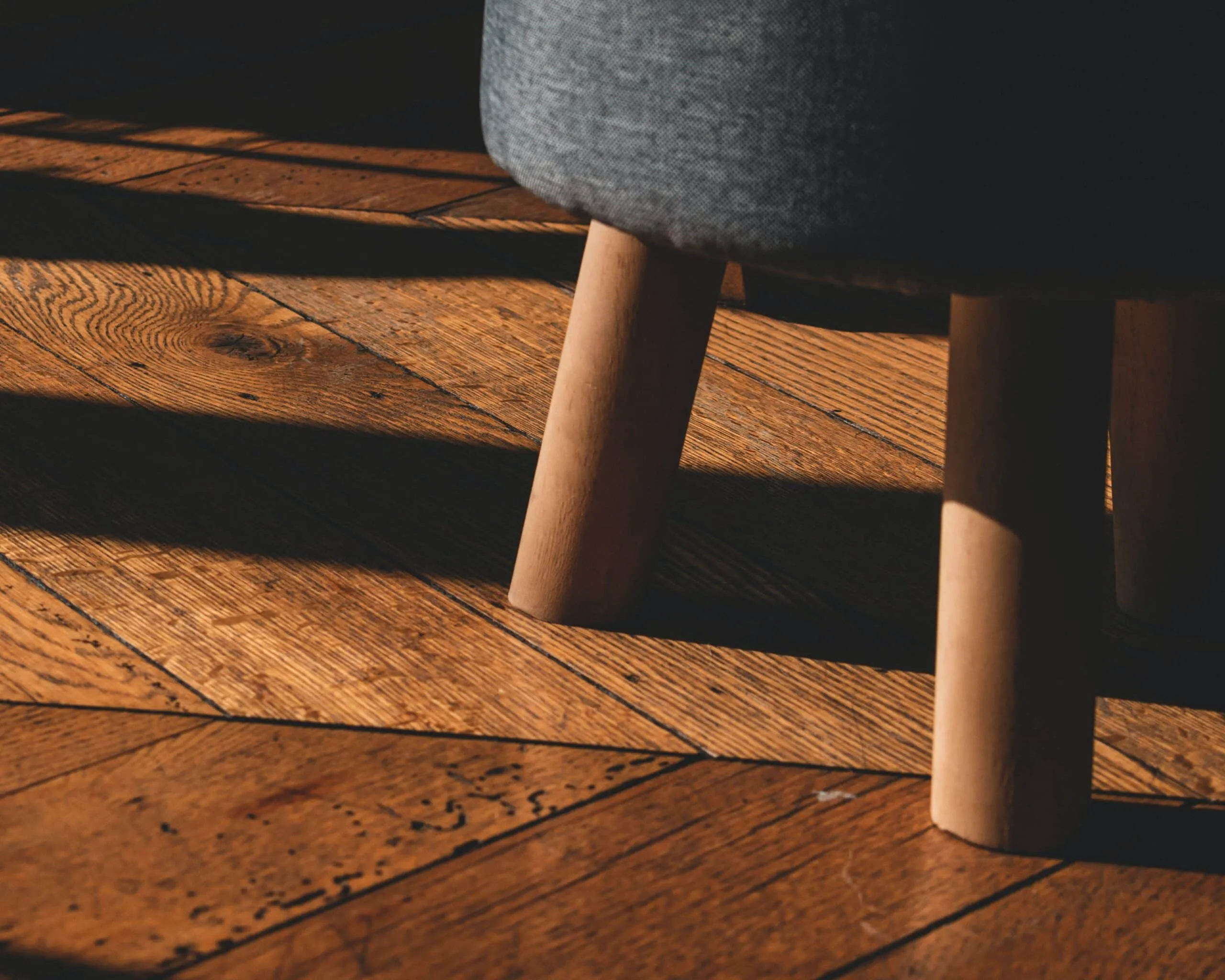 Close view of wood floor and stool.